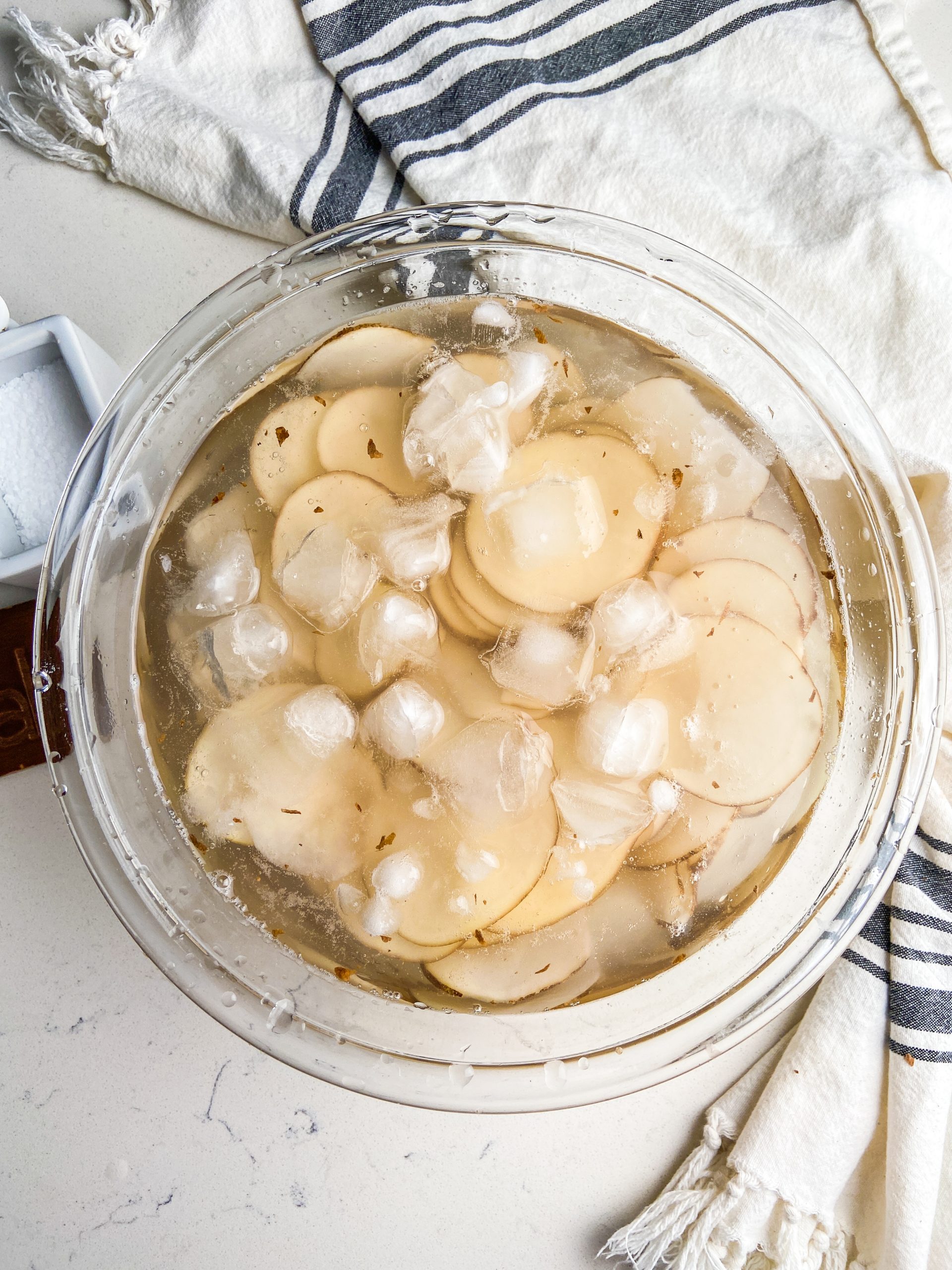 Potato slices soaking in ice water.