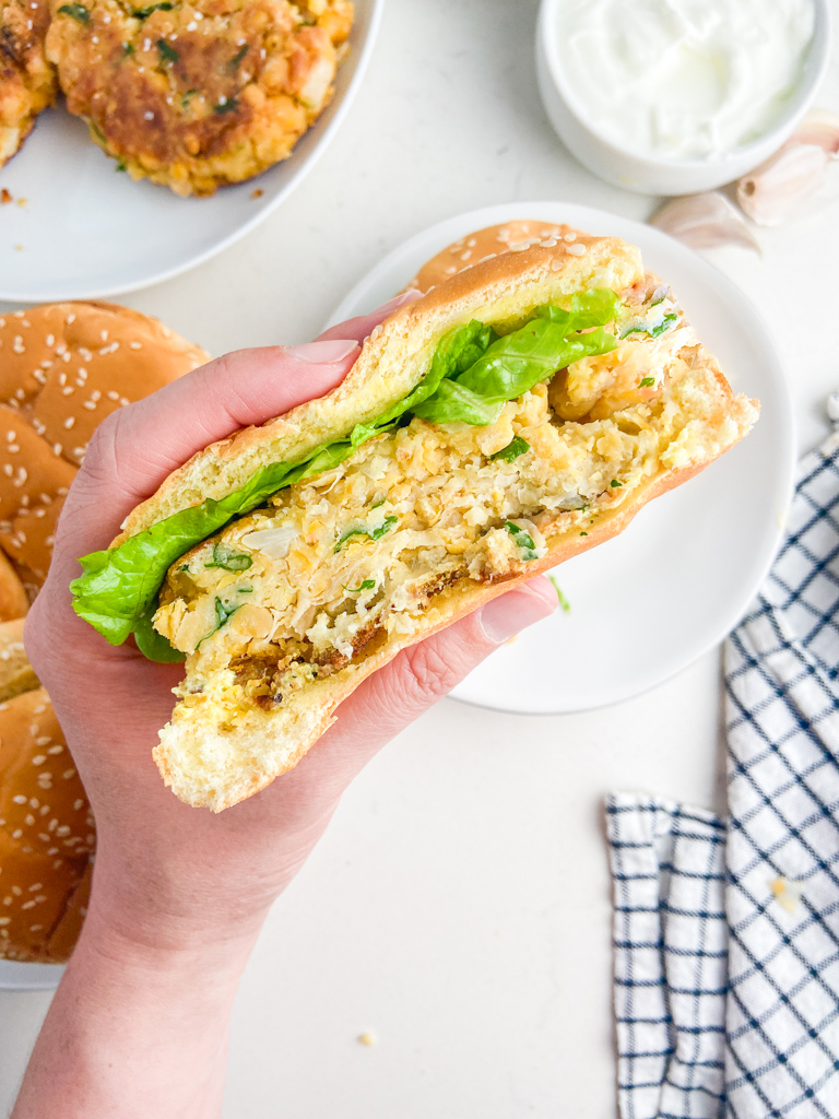 Hand holding chickpea burger. 
